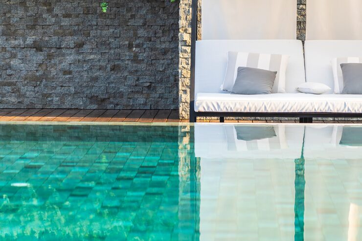 Outdoor swimming pool with umbrella lounge chairs leisure travel resort